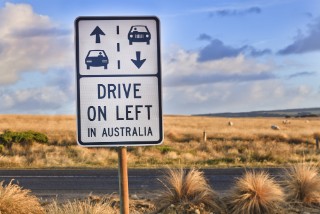 272625500 A road sign reading "Drive on left in Australia".