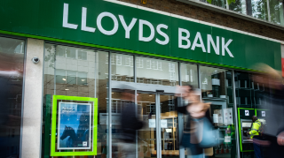LONDON- MAY, 2019: Lloyds bank exterior with motion blurred people. A British high street retail and commercial bank. 