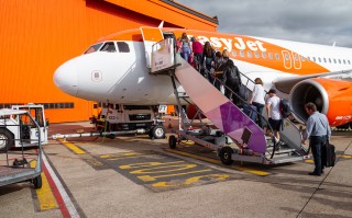 LUTON, UNITED KINGDOM - MAY 31, 2019: Passengers boarding EasyJet Airbus A319 at London Luton International Airport.