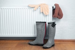 Heating radiator with rubber boots and warm clothes indoor