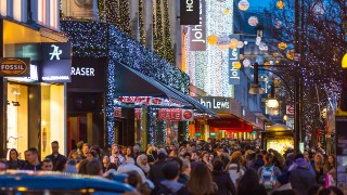 LONDON, UK - DECEMBER 30, 2015: Christmas lights decoration at Oxford street and lots of people walking during the Christmas sale,