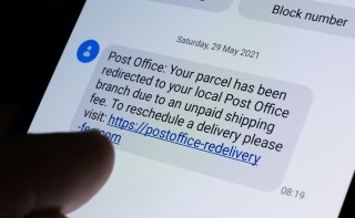 Genuine scam message seen on smartphone screen. Unpaid parcel shipping fees scam text. (Link is not active). Stafford, United Kingdom, June 7, 2021.
