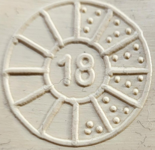 an image of a wheel split into 12 segments. 5 of the segments has 4 dots within them. The 6th segment has 3 dots. This means the bottle was made in the 3rd week of June 2018.
