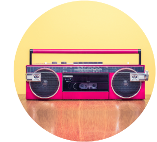 Pink, old-fashioned radio/cassette player Pink, old-fashioned radio/cassette player with a handle on top.
