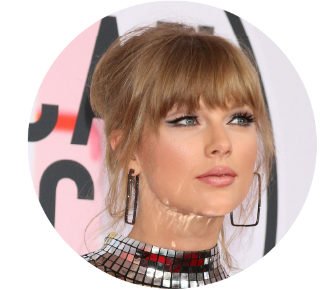 Close up of Taylor Swift with her hair up and wearing large rectangle earrings.  