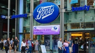 London, UK, July 5, 2019: View from the street of Boots pharmacy on Oxford Street. People passing by
