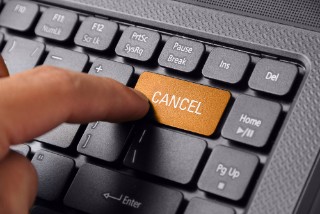 406414858 This image features a computer keyboard with the Cancel key highlighted in orange