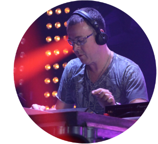 Close up of Judge Jules looks at the decks while playing a live DJ set.