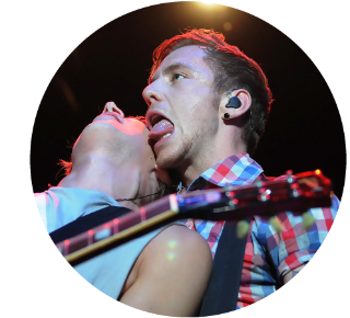 Danny Jones of McFly sticking his tongue out while playing live.