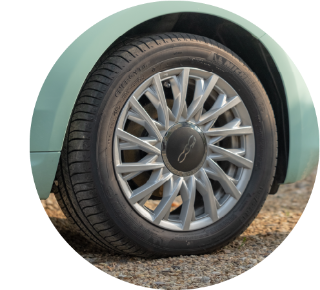 Close up of wheel on stationary car parked on gravel Close up of wheel on stationary car parked on gravel.