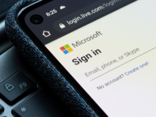 Microsoft sign in on a smartphone Close up of the Microsoft sign in page displayed on a smartphone laying on a laptop keyboard.