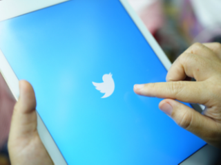 Twitter on a tablet Close up photograph of a person opening Twitter on a tablet.