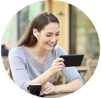 Young woman laughing while watching something on a smartphone.