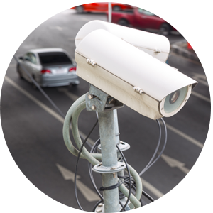 Close up of two white traffic cameras on a grey pole, pointing in different directions.