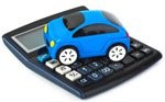 A blue toy car sitting on the keypad of a black desktop calculator.