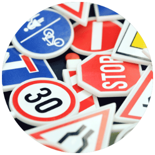 Road signs Close up of a variety of road signs overlapping one another.