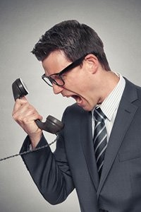 Man shouting into a telephone Man shouting into a telephone