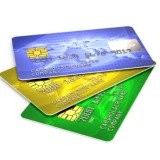 Blue, gold and green credit cards fanned out on a surface.