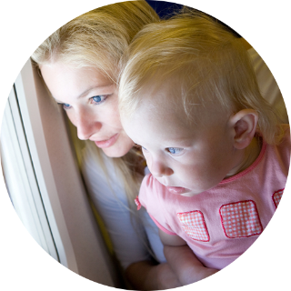 parent looking out airplane window with kid