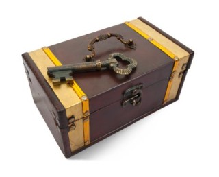 Wooden chest with a lock and handle, with a large key laying on top of it.