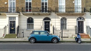 UK, London - February 20 2021: Mini car and scooter parked in a street in Belgravia, London