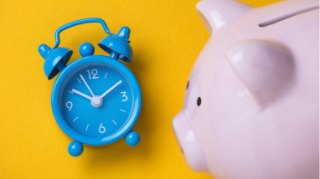 A blue alarm clock and a pink piggy bank on a yellow background.