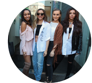 Little Mix The four members of Little Mix standing next to each other and smiling.