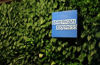 NEW YORK CITY, USA â€“ AUGUST 14 2015: American Express logo on display in the AMEX Centurion Lounge at New York LaGuardia Airport. A green living wall greets guests at the entrance.