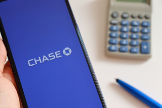Bahia, Brazil - April 5, 2021: Hand holding smartphone with Chase bank app on screen. Internet banking concept.