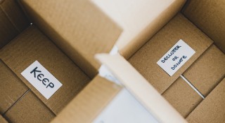 Two cardboard boxes, one labelled 'Keep', the other labelled 'declutter or donate'