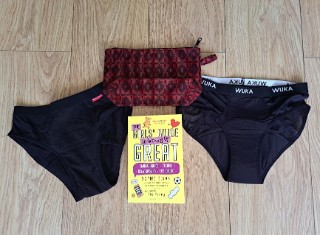 Two pairs of black knickers, an empty cosmetics bag and a book entitled 'The Girls' Guide to Growing up Great'