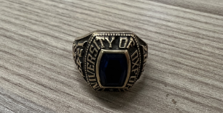 Chunky gold ring on a table