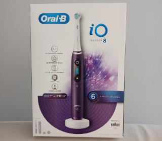A boxed purple Oral-B electric toothbrush
