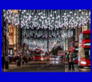 Strings of star-shaped lights hanging down over Oxford Street at night