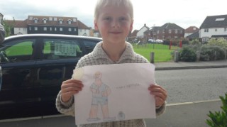 7-year-old Hayden holding up his drawing 7-year-old Hayden holding up his drawing